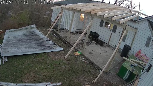 wood rafters and posts where the carport was