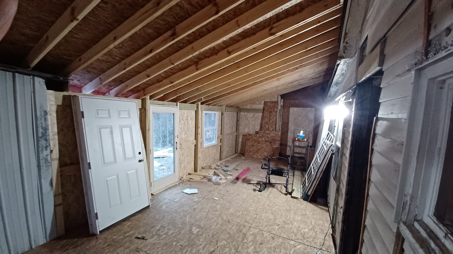 unfinished room with wood trusses and walls exposed